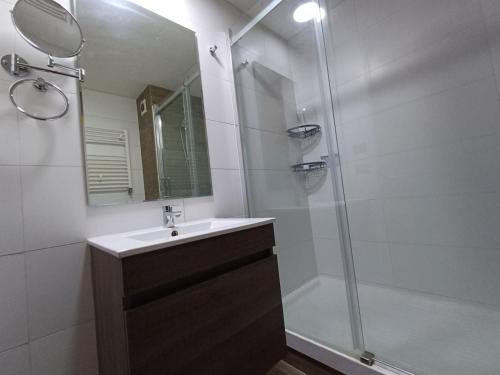 a bathroom with a sink and a shower with a mirror at Gran Parador, El Colorado, ski in-out in Santiago