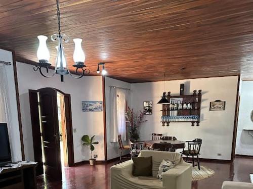 a living room with a couch and a table at Pequeno Paraiso in Campos do Jordão