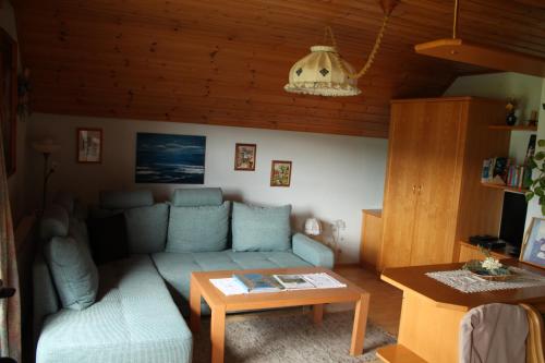 a living room with a couch and a table at Lassacher Biobauernhof in Mariapfarr
