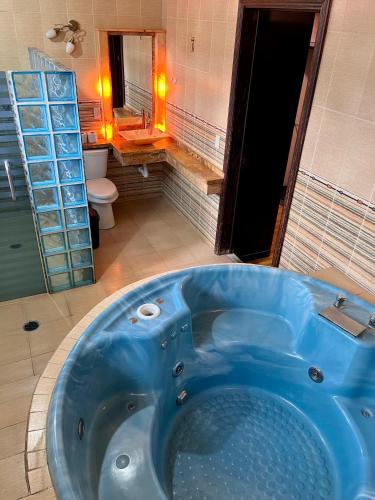 a blue tub in a bathroom with a toilet at Gran México in Mexico City