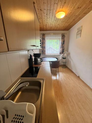 a kitchen with a sink and a table in it at Gasthof Barlida in Lainach