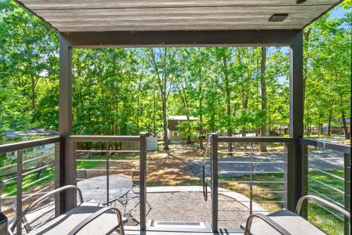 a screened porch with chairs and a view of a park at Glamping at KY Lake 1 min from Carper Cove in Springville
