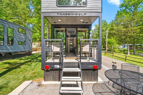 a tiny house with stairs leading to the back of it at Glamping at KY Lake 1 min from Carper Cove in Springville