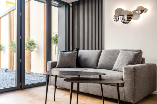 a living room with a couch and a table at Studios Le Médicis in Rouen