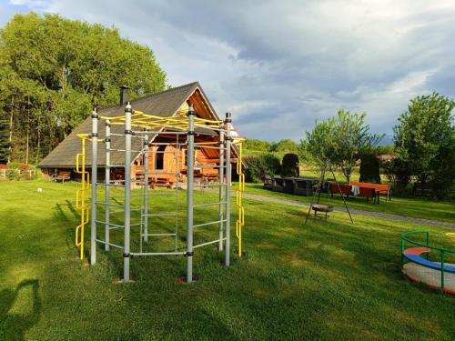 a playground in a yard with a house at Willa Zielona Polana in Czarna Góra