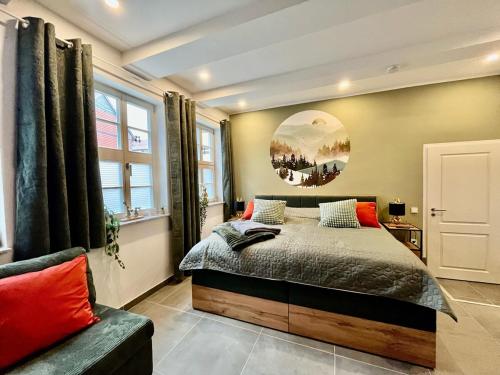 a bedroom with a large bed and a couch at Eckstück in Wernigerode