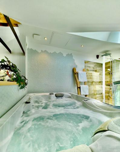 un jacuzzi dans le coin d'une pièce dans l'établissement Nid douillet sous les toits avec jacuzzi, à Bagnères-de-Bigorre