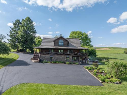 an image of a large house with a driveway at The Lodge at Fields of Home in Millersburg