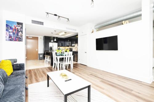 a living room with a couch and a table at Sky-Rise Apartments in Los Angeles