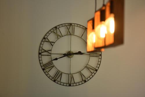 a clock on the side of a wall at Rent Your Family Retreat in Novi Sad in Novi Sad
