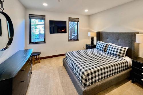 a bedroom with a bed and a desk and windows at Truckee Mountain Retreat in Truckee