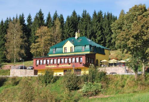 a building with a bird sitting on top of it at Penzion Vyhlídka Janovičky in Broumov