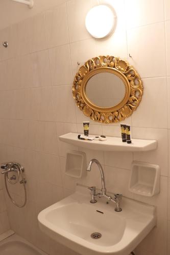 a bathroom with a sink and a mirror at Themis - Θέμις Apart Hotel in Loutra Edipsou