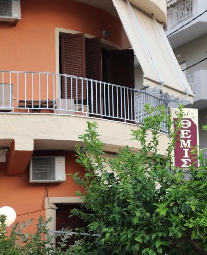 a balcony of a building with a dog on it at Themis - Θέμις Apart Hotel in Loutra Edipsou