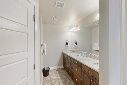 a bathroom with a sink and a large mirror at The Desert Star Villa in Washington