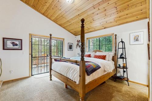 a bedroom with a bed and a wooden ceiling at Chill on the Hill in Truckee