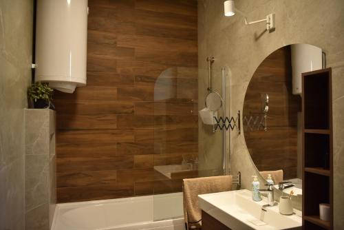 a bathroom with a tub and a sink and a shower at Rent Your Family Retreat in Novi Sad in Novi Sad