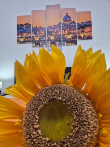 a sunflower in front of a picture of a mosque at Aura Station Ciampino in Ciampino