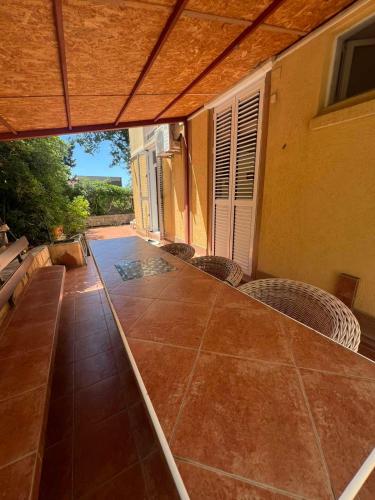an outdoor patio with chairs and a table with a view at Sunny Lemon Garden in Petrovac na Moru