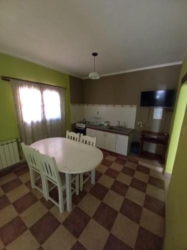 a kitchen with a table and chairs in a room at Departamentos Complejo Turístico Cruz Mendoza in Tilcara