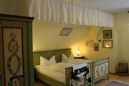 a bedroom with a bed with white pillows at Hotel zum Kreuz in Sankt Peter