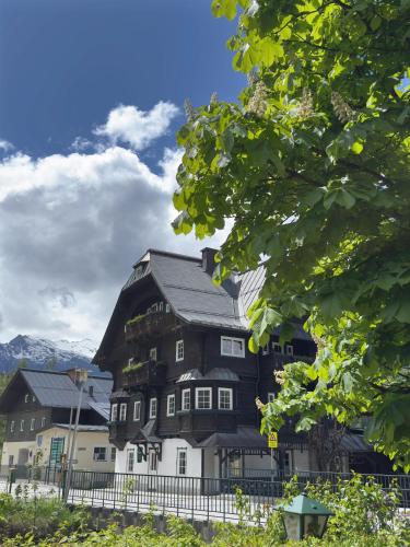 a large black and white house with a fence at Villakraft in Bad Gastein