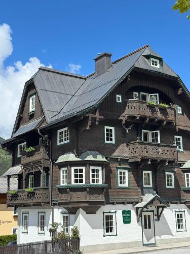 a large wooden house with a black roof at Villakraft in Bad Gastein
