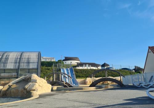 a water park with a slide and a playground at Mobil-home Vue mer Piscine - Camping La Falaise Equihen-Plage - La Coquille d'Opale in Équihen-Plage