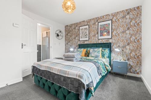 a bedroom with a bed and a wall with wallpaper at #16 Detached Stunning Lux 3 Bed home Parking NEC in Marston Green