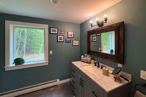 a bathroom with a sink and a mirror and a window at River Haven in Newfane