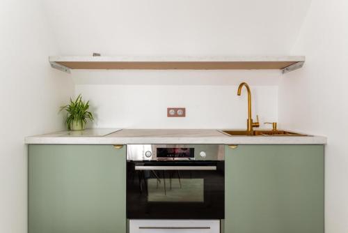 a kitchen with a sink and a stove at Studios Le Médicis in Rouen
