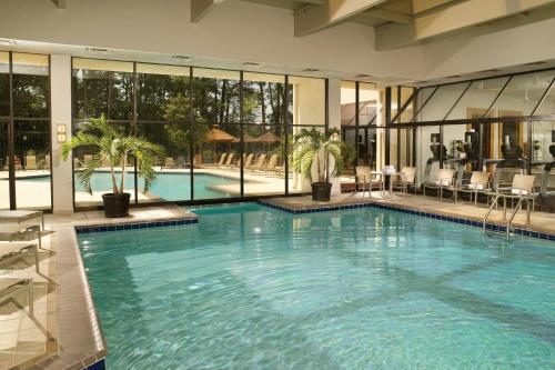 a large swimming pool in a building with windows at Atlanta Marriott Perimeter Center in Atlanta
