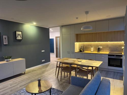 a kitchen and dining room with a table and chairs at MANTO NAMAI apartment in the center of Klaipeda with a view in Klaipėda