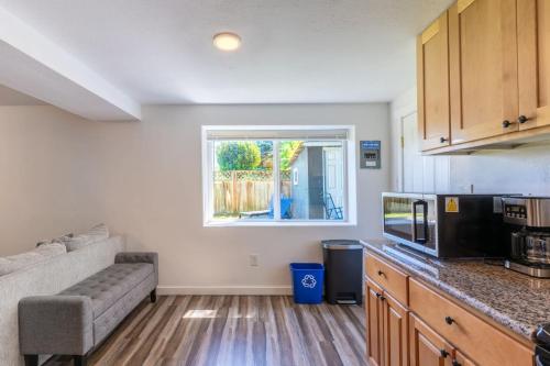 a kitchen with a couch and a window in a room at Entire Apt in South Seattle Workspace and Yard in Seattle