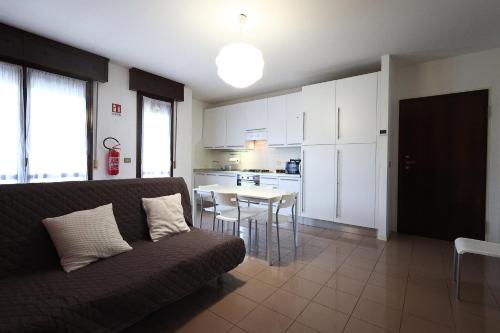 a living room with a couch and a table with chairs at Alby's apartment, nella Motor Valley con parcheggio privato in Formigine