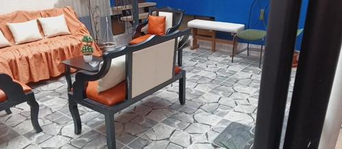 a bedroom with a bed and a table with a chair at HOSTAL CALIFORNIA STAR QUITO in Quito