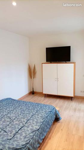 une chambre avec un lit et une télévision à écran plat dans l'établissement Casa Ozeana, à Biarritz