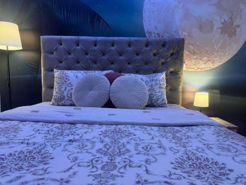 a bedroom with a bed with a headboard and pillows at Secret Spa Nis in Niš
