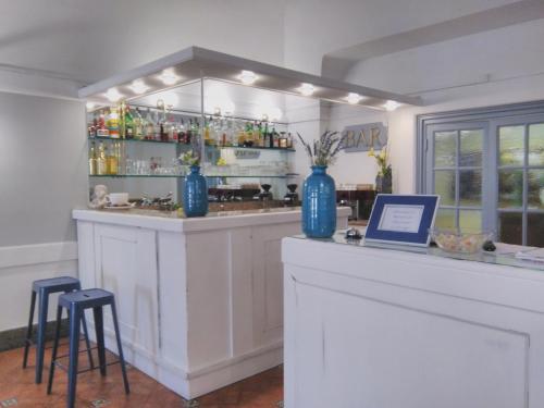 a bar with blue vases on top of it at Sunbay Park Hotel in Civitavecchia