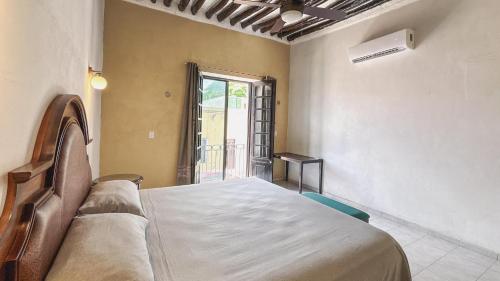 a bedroom with a bed and a window at Casa Santa María Valladolid in Valladolid