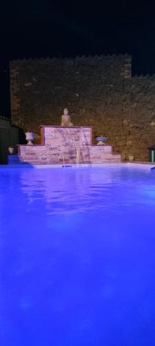a stage with blue lights on the water at night at Cal Belló Casa rural in Lleida