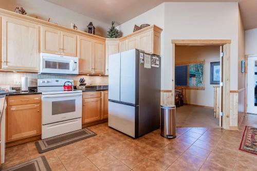 a kitchen with a refrigerator and a stove at Incredible Views w Garage on Lake and bike trail in Tofte
