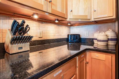 a kitchen with wooden cabinets and a counter top at Incredible Views w Garage on Lake and bike trail in Tofte
