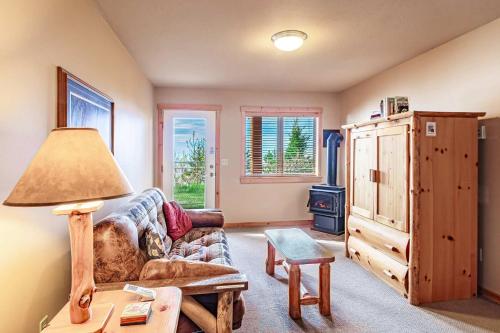 a living room with a couch and a table at Incredible Views w Garage on Lake and bike trail in Tofte