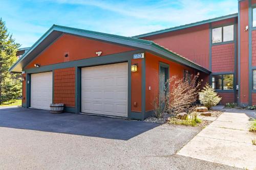 a red house with two garage doors at Incredible Views w Garage on Lake and bike trail in Tofte