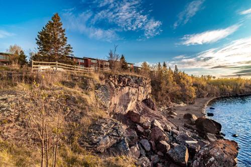a train on the tracks next to a river at Incredible Views w Garage on Lake and bike trail in Tofte