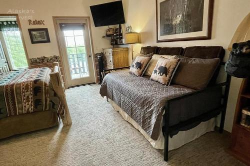 a bedroom with a bed with pillows on it at Alaska's Harvest Bed and Breakfast and Luxury Log Cabin in Palmer