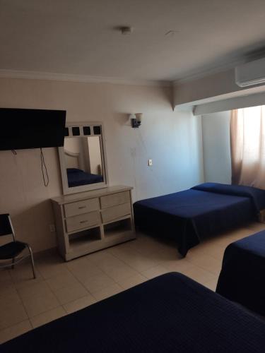 Postel nebo postele na pokoji v ubytování Hotel del Paseo