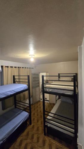 a room with three bunk beds in it at Hostel & Privativo in Manaus