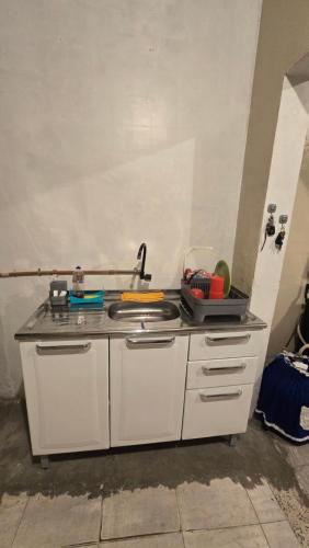 a kitchen counter with a sink in a room at Hostel & Privativo in Manaus